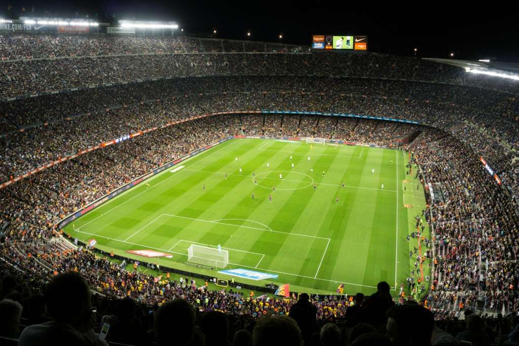 people watching soccer game in stadium