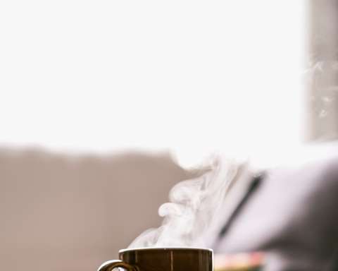 shallow focus photography of hot coffee in mug with saucer