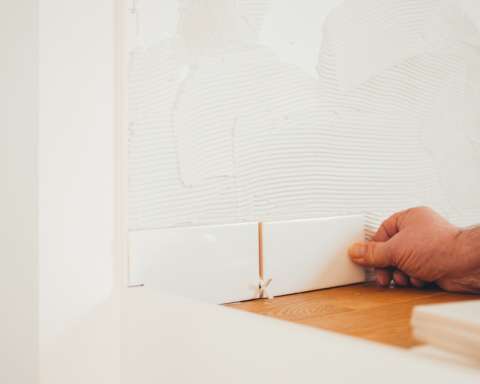 person holding white tile