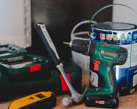 red and black cordless power drill beside black and red cordless power drill