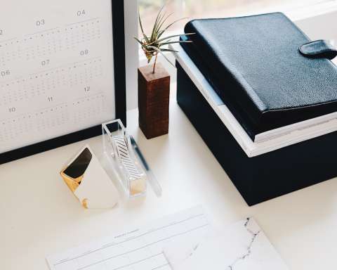 books and calendar on white table